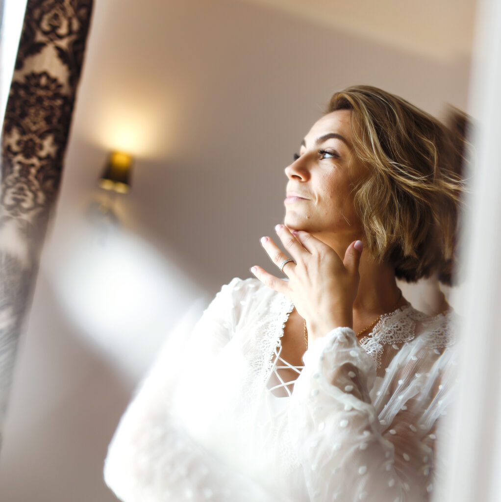 bride-in-elegant-white-dress-looking-in-mirror-th-2026-03-20-00-18-57-utc